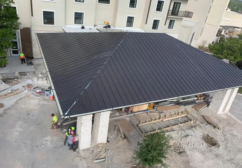 Metal roofing installation team working on a commercial building in Interlaken