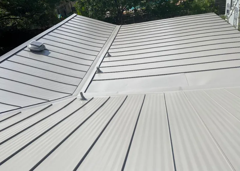 Solar attic fan installed on a metal roof for Roof Ventilation in Interlaken